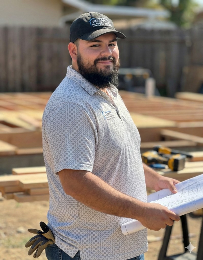 Cristian Franco holding blueprints on a construction site in Lincoln, California